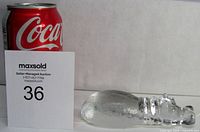 Crystal hippo paperweight next to a Coca-Cola can for size reference, showing the overall length and shape of the figurine.