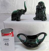 Front and side view of three Blue Mountain Pottery ceramic pieces: an elephant figurine, a cocker spaniel figurine, and a two-handled sugar bowl with handles. A Campbell's soup can included for scale.