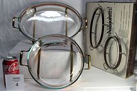 Set of two copper casserole trays with Pyrex glass inserts and original box shown with Coca-Cola can for size reference.