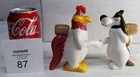 Front view of Foghorn Leghorn and Barnyard Dawg salt and pepper shaker set with Coca-Cola can for size reference.