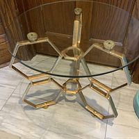 Angle view of gold hexagon base and glass top