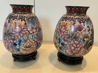 Front view of both cloisonné vases on stands