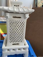 Front view of white ceramic pagoda lamp showing lattice sides and roof lid