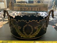 Front view of jardiniere showing swan handles, painted decoration and scale