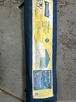 Blue Broadstone Gallaghan 8-Person Portable Sporting Tent fabric packed inside a blue canvas carry bag with label.