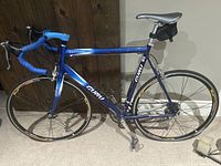 Full left-side profile of blue Rolf Guru Vector Comp bicycle showing frame, fork, wheels, saddle and accessories