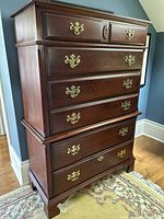 Front view of tallboy dresser showing 6 drawers and brass hardware