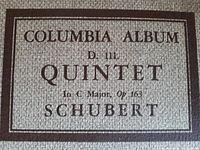 Close-up of a textured portfolio cover titled 'Columbia Album D. 111 Quintet in C Major, Op 163 Schubert'