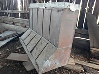 Full view of large commercial exhaust hood made of copper front panels and galvanized metal back, showing wear and patina.