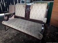 Full view of the Victorian style settee showcasing wooden frame, patterned upholstery, and armrests.