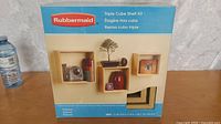 Front view of Rubbermaid Triple Cube Shelf Kit new in box showing brand, product name and shelf measurements.