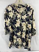 Front view of extra large navy blue Hawaiian shirt with white flower pattern hanging on a hanger.