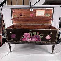 Open chest showing interior cedar wood lining, floral painting on inside of lid and original Lane label affixed to inside lid.