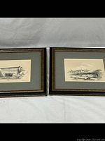 Two framed horizontal prints side by side with grey mats and wooden frames showing detailed historical ruins.