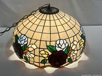 Full view of dome-shaped stained glass shade and hanging chain