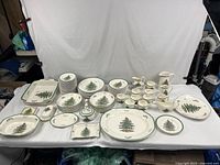 Full layout of plates, bowls, serving pieces and accessories on white backdrop