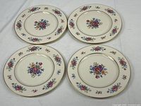 Four Lennox Rose J-300 floral plates arranged side by side showing full floral pattern and gold rims.
