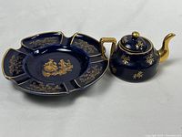 Full view of the blue and gold Limoges ashtray and mini teapot on white background.