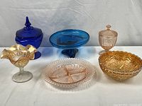 Full view of the six glass pieces showing color, size, and shape variety.