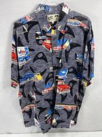 Front view of the button up shirt showing all-over hot rod car print on gray background with black abstract shapes.