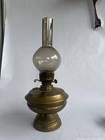 Full side view of the 18-inch brass oil lamp with clear glass chimney showing shape and condition.
