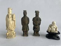 Front view of four figurines arranged in a row showing size and colors