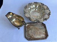 Top-down view of all three items on white background showing scalloped bowl, rectangular tray, and gravy boat