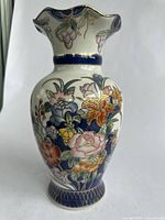 Full view of ceramic vase showing shape and floral design.