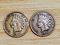 Obverse side of two 1907 Indian Head pennies showing Liberty head with Native American headdress.