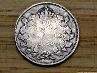 Reverse side of the coin showing the crown, leaves, denomination and year 1920, with visible tarnish and wear.