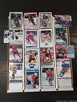 Four boxes of NHL hockey cards stacked tightly, showing the card fronts of various players from teams including Rangers, Capitals, Flyers, and others.