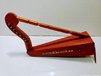 Image showing full handcrafted miniature harp with wood grain visible and label 'Recuerdo de Tijuana, B.C.'