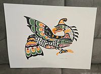 Full view of the colorful Thunderbird print showing detailed Indigenous art style bird with green, orange, black and white colors.