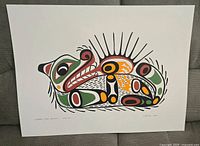 Framed print showing colorful indigenous style depiction of an otter with sea urchin, titled 'Otter with Sea Urchin'