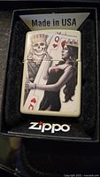 Zippo lighter with detailed Queen of Hearts and skull artwork in box