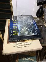 Photo showing two local history books stacked with visible titles: "The Beauty of Renfrew & Area" and "Daniel Fowler of Amherst Island 1810-1894".