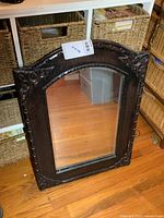 Front view of the 20x28 wall mirror showing dark ornate carved frame and mirror glass