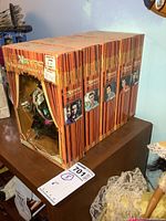 Side view of all 5 NSYNC On Tour 2000 Collector's Edition dolls in their original boxes featuring images of the band members on box spines.