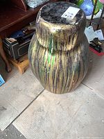 Owl shaped pedestal with wood grain painted finish visible scuffs and wear.