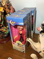 Five boxed dolls lined up, showing count and overall box condition