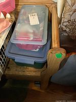 Two small plastic totes stacked, containing various TY Beanie Babies and plush toys.