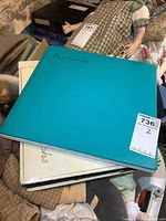 Two large albums stacked one on top of the other labeled 'Postcards'.