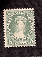 Front view of the 1860 New Brunswick Queen Victoria 5 Cent postage stamp showing the detailed portrait in green with perforated edges.