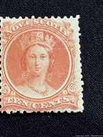 Front side of the 1860 Nova Scotia 10 cent Queen Victoria stamp in pink hue showing portrait and text details.