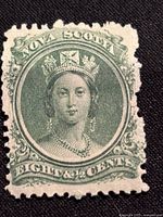 Front side of the 1860 Nova Scotia green postage stamp featuring Queen Victoria, denomination 8½ cents, showing the portrait in detail and text.