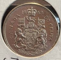 Reverse side of the 1963 Canadian 50-cent coin showing the updated Canadian Coat of Arms with the year 1963, CANADA, and 50 CENTS text.
