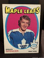 Front of Brian Spencer rookie card showing player portrait in Toronto Maple Leafs jersey with colorful background and card title.