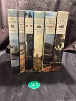 Spine view of the six-book set showing the titles and consistent design of the 1995 Book of the Month Club hardcover editions with dust jackets.