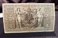 Reverse side of the 1910 German 1000 Mark banknote showing detailed ornate border, floral motifs, and the Imperial eagle emblem.