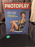 Front cover photo showing Debbie Reynolds posing on a chair with blue background and magazine title Photoplay, dated October 1960.